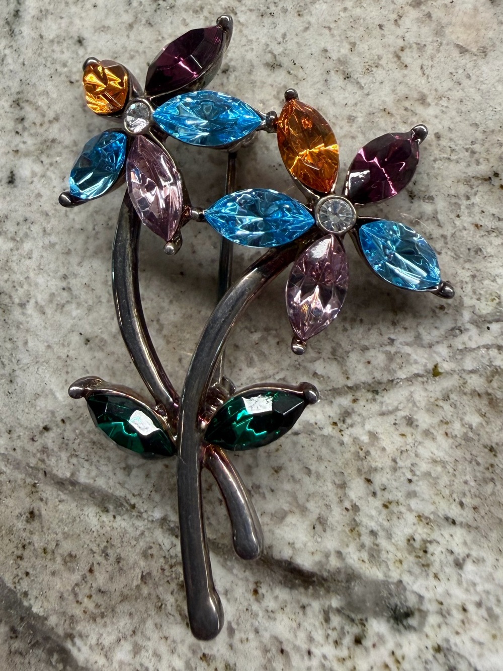 Vintage Monet silver tone/rhinestone pinwheel flower brooch .